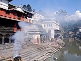 Kathmandu Pashupatinath 09 Burning Ghats Next To Pashupatinath Temple Burning ghats used for cremating the dead jut out on the Bagmati river bank at Pashupatinath in Kathmandu. Male members of the family lay the deceased relative on the wood and straw funeral pyre, and ghee (clarified butter) is laid on the logs to help them burn. Please show discretion for these intensely personal religious affairs.